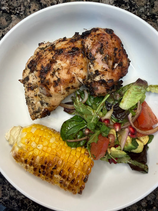 Grilled chimichurri chicken thighs topped with Jenny Food's Chimichurri sauce